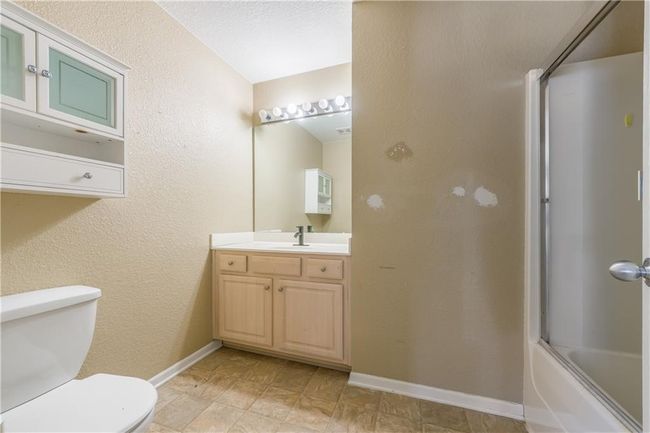 Bathroom with baseboards, toilet, and vanity | Image 10