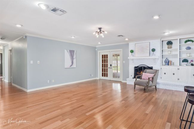 Living area featuring light wood-type flooring, visible vents, and crown molding | Image 6