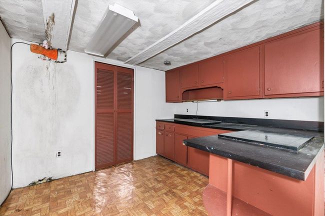 Kitchen featuring dark countertops and a peninsula | Image 12