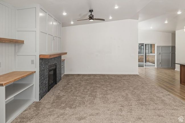 Carpeted living room with ceiling fan | Image 6