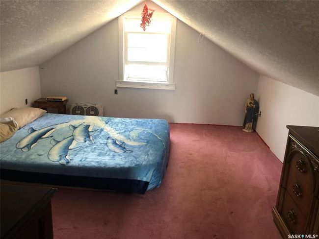 Bedroom featuring carpet flooring, lofted ceiling, and a textured ceiling | Image 41