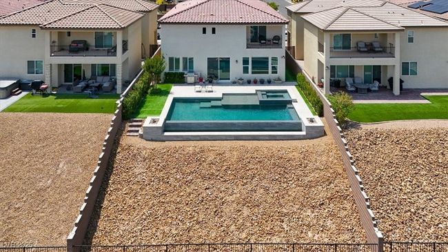 Back of house with a balcony, stucco siding, an outdoor hangout area, and a patio | Image 64
