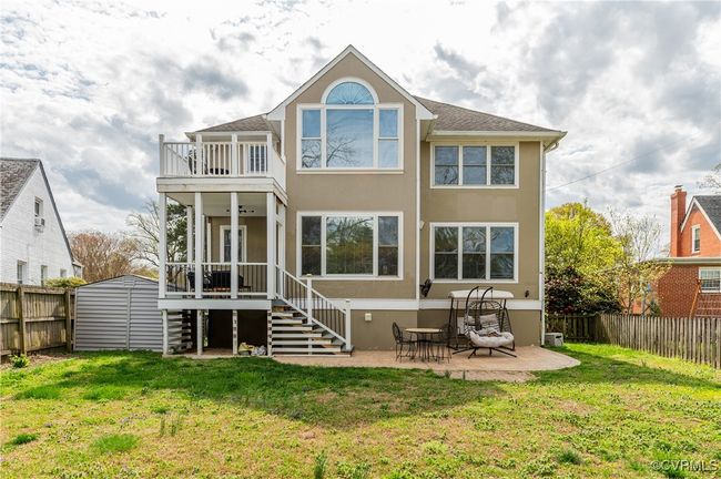 Back of house with a shed, an outbuilding, a fenced backyard, a balcony, and a yard | Image 46