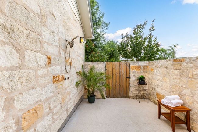 Enjoy a refreshing rinse surrounded by nature, just steps from the primary suite. | Image 19