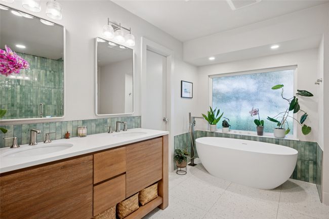 Ensuite bathroom with garden tub, privacy glass, and sleek double vanity. | Image 13
