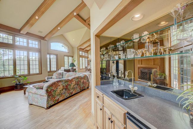 Enjoy cocktail hour with this wet bar thoughtfully positioned off the great room and with convenient access to the deck space | Image 9