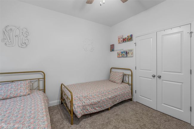 Carpeted bedroom with a closet and a ceiling fan | Image 21
