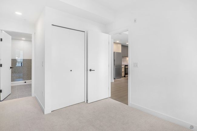 Primary Bedroom with a closet, light carpet | Image 12