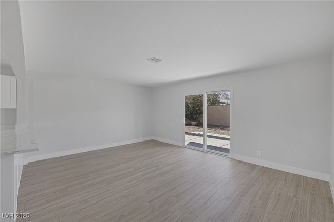Empty room with light wood-style flooring and baseboards | Image 16
