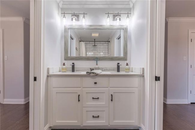 Bathroom with wood-type flooring, vanity, walk in shower, and crown molding | Image 20