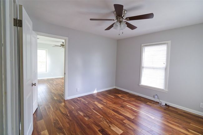 Third bedroom connects with primary bedroom for convenient use as office or nursery. | Image 14
