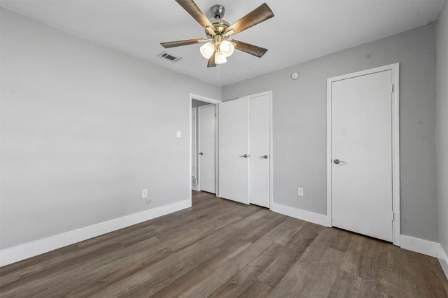 Unfurnished bedroom featuring ceiling fan and hardwood / wood-style floors | Image 24
