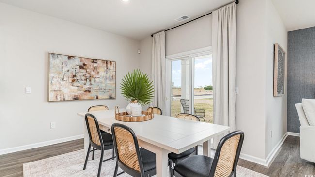 Dining room with wood finished floors, baseboards, and recessed lighting | Image 7