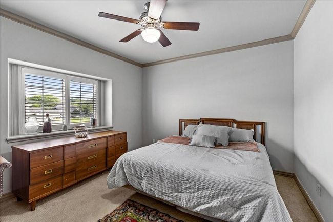 Experience the tranquil charm of this third upstairs bedroom—a welcoming retreat where the beauty of the bay and the comfort of home come together in perfect harmony. | Image 37