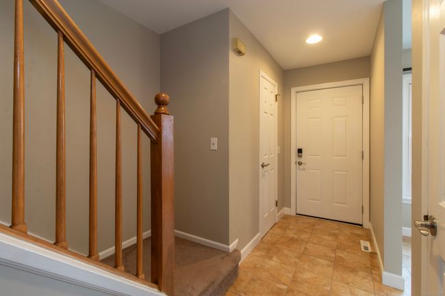 Entry way with door to half bath and opens to the kitchen and stair case | Image 6
