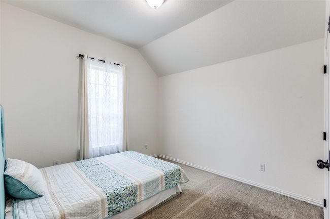 Carpeted bedroom with vaulted ceiling and baseboards | Image 20