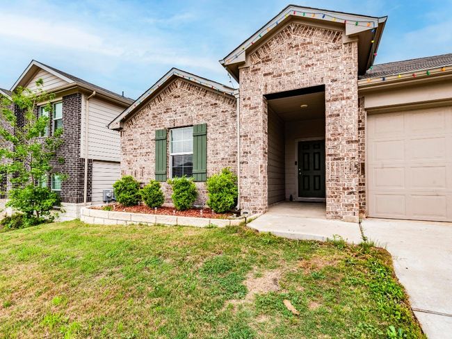 View of front of house with an attached garage, a front lawn, concrete driveway, and brick siding | Image 5