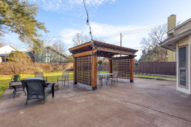 Outside, the backyard transforms into your very own private sanctuary, surrounded by mature trees that provide shade and a sense of tranquility that makes this space feel completely secluded | Image 25