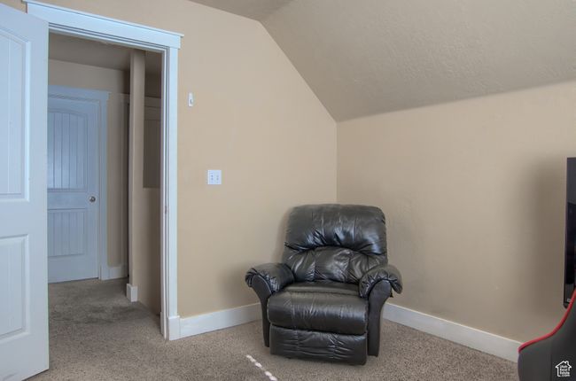 Sitting room featuring baseboards, vaulted ceiling, and carpet | Image 24