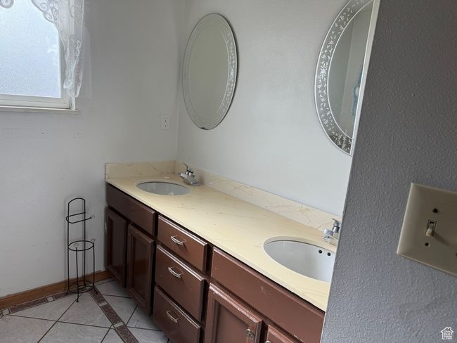 Full bath featuring tile patterned flooring, a sink, and double vanity | Image 14