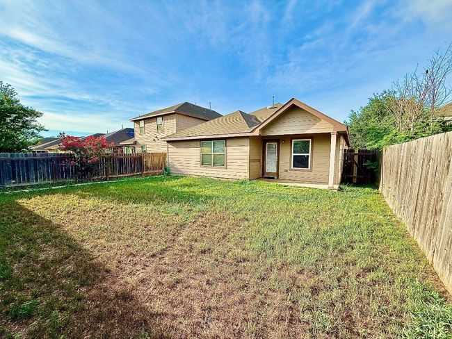 Back of property with a fenced backyard | Image 21