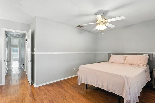 Bedroom featuring wood finished floors and ceiling fan | Image 13