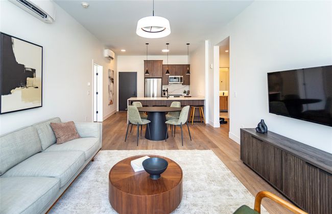 Inside, style and sophistication define each residence, where open floor plans seamlessly connect the sleek modern kitchen, dining area, and living room. All photos are of the furnished model unit #305 with 1, 089 SF. | Image 11