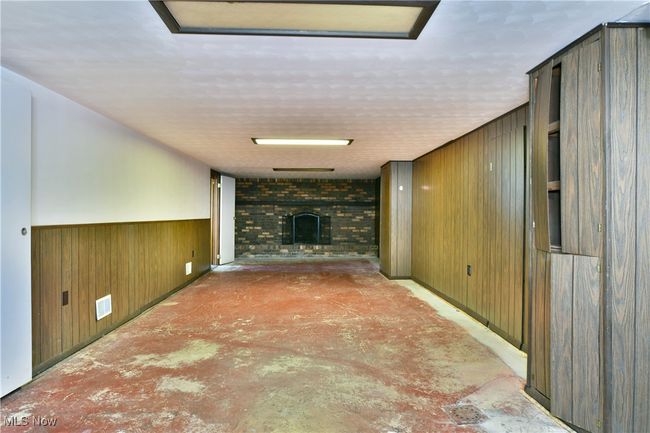 Corridor featuring wood walls, a wainscoted wall, and visible vents | Image 35