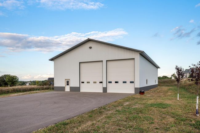 The massive 87x50 heated outbuilding boasts 18-foot ceilings. | Image 27