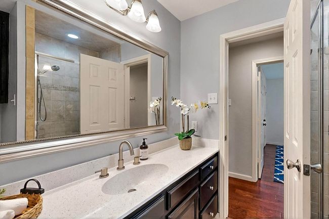 Full bath with vanity, wood finished floors, and tiled shower | Image 26