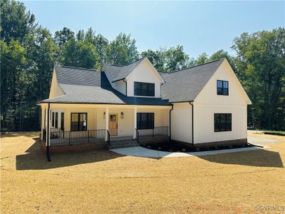 Modern farmhouse style home with a porch | Image 1