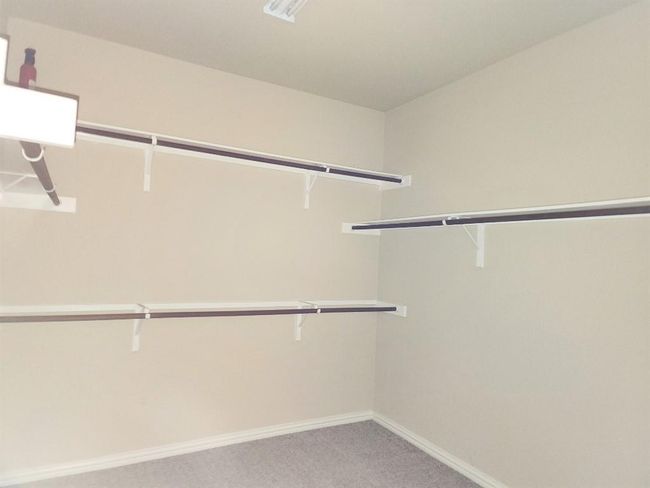 Spacious closet featuring light carpet | Image 17