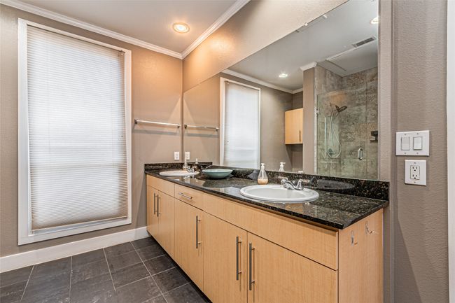 Full bath with ornamental molding, double vanity, a shower stall, tile patterned flooring, and recessed lighting | Image 21