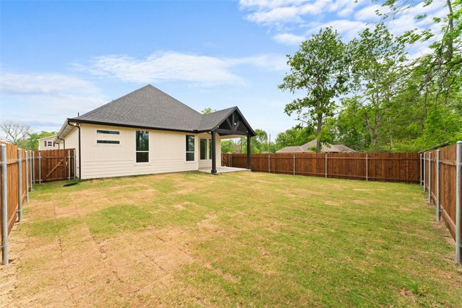 View of yard with a fenced backyard and a patio area | Image 31
