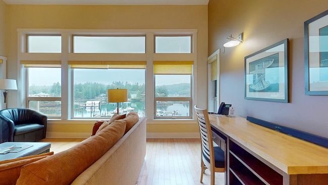 Living area with light wood finished floors, baseboards, and a wealth of natural light | Image 14