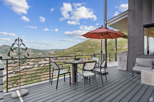 Wooden terrace with a mountain view and outdoor dining area | Image 44
