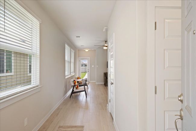 Hallway featuring light wood-type flooring and baseboards | Image 4