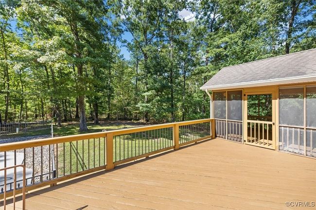 Wooden deck with a sunroom= | Image 23
