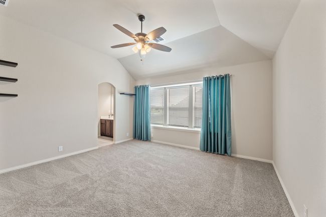 large bedroom with lofted ceiling, light colored carpet, and ceiling fan | Image 26