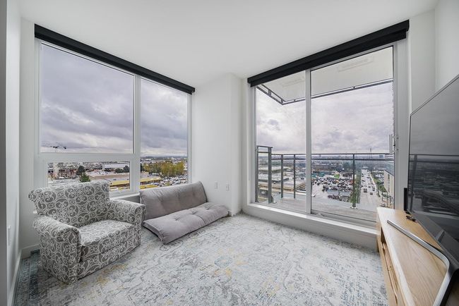 Living room featuring plenty of natural light and floor to ceiling windows | Image 7