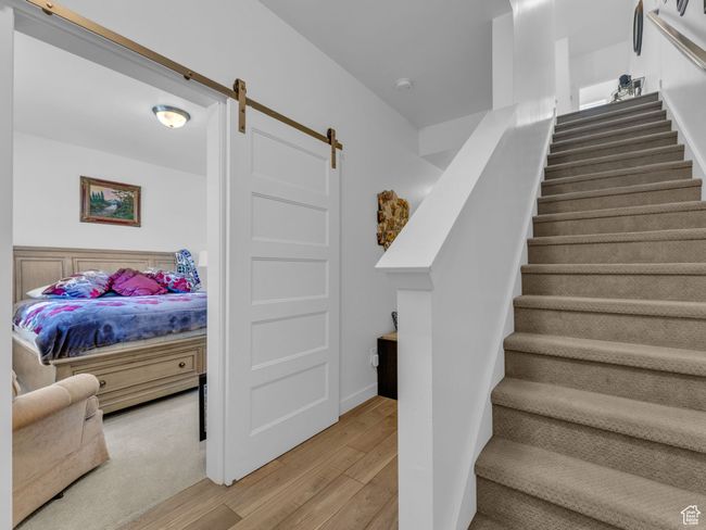 Staircase featuring wood finished floors and a barn door | Image 16
