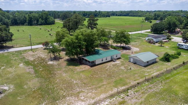 Aerial view of sparsely populated area featuring agricultural land | Image 33