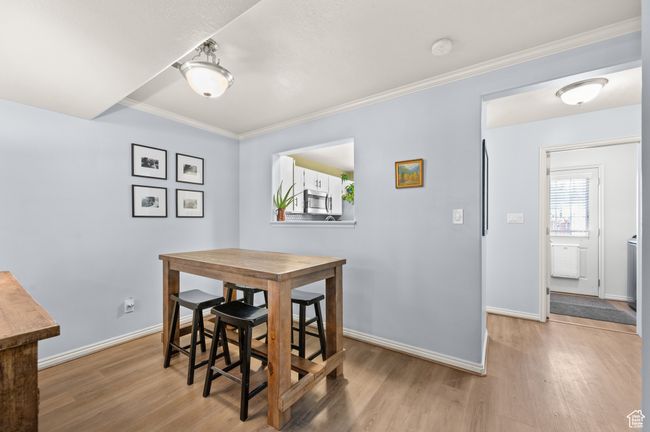 Dining space featuring light wood-style flooring and crown molding | Image 7