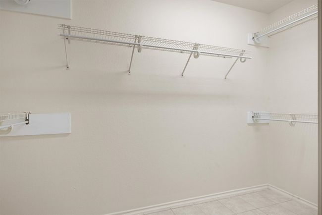 Walk in closet with light tile patterned floors | Image 15