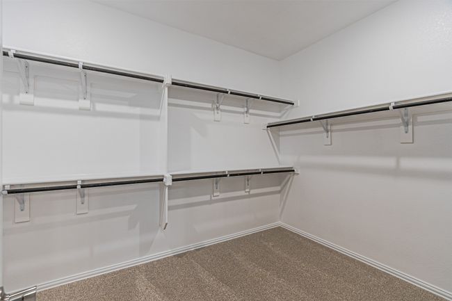Walk in closet featuring carpet | Image 28