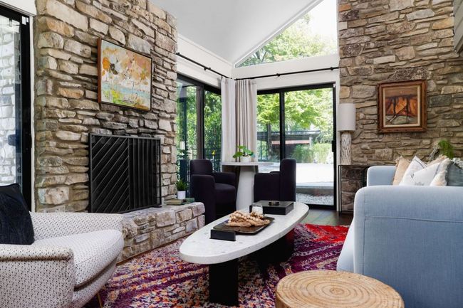 Living room with high vaulted ceiling, a fireplace, and wood finished floors | Image 24