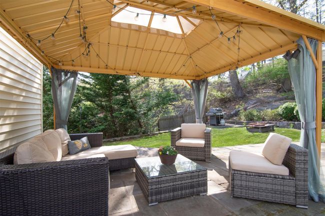 View of patio featuring an outdoor living space, a gazebo, area for grilling, and fence | Image 19