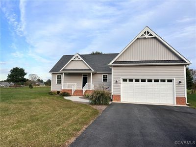 Craftsman inspired with front porch and garage home with a front yard, a porch, and a garage | Image 1