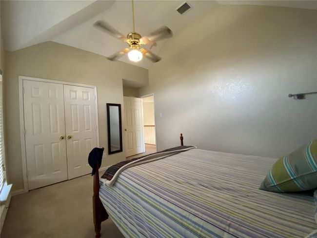 Bedroom featuring ceiling fan, a closet, carpet, and vaulted ceiling | Image 26