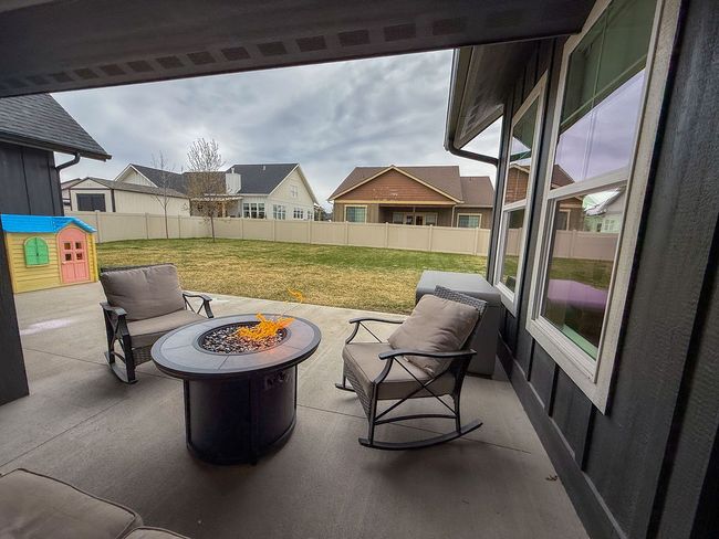 Covered patio facing large, fenced backyard | Image 22